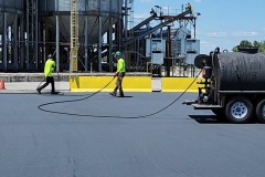 Asphalt-Spray-Sealing-Over-First-Coat-Squeegee